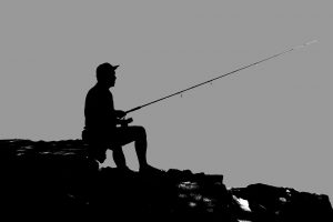 fisherman holding fishing rod