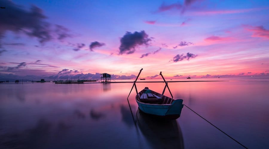 A boat on a lake at sunrise